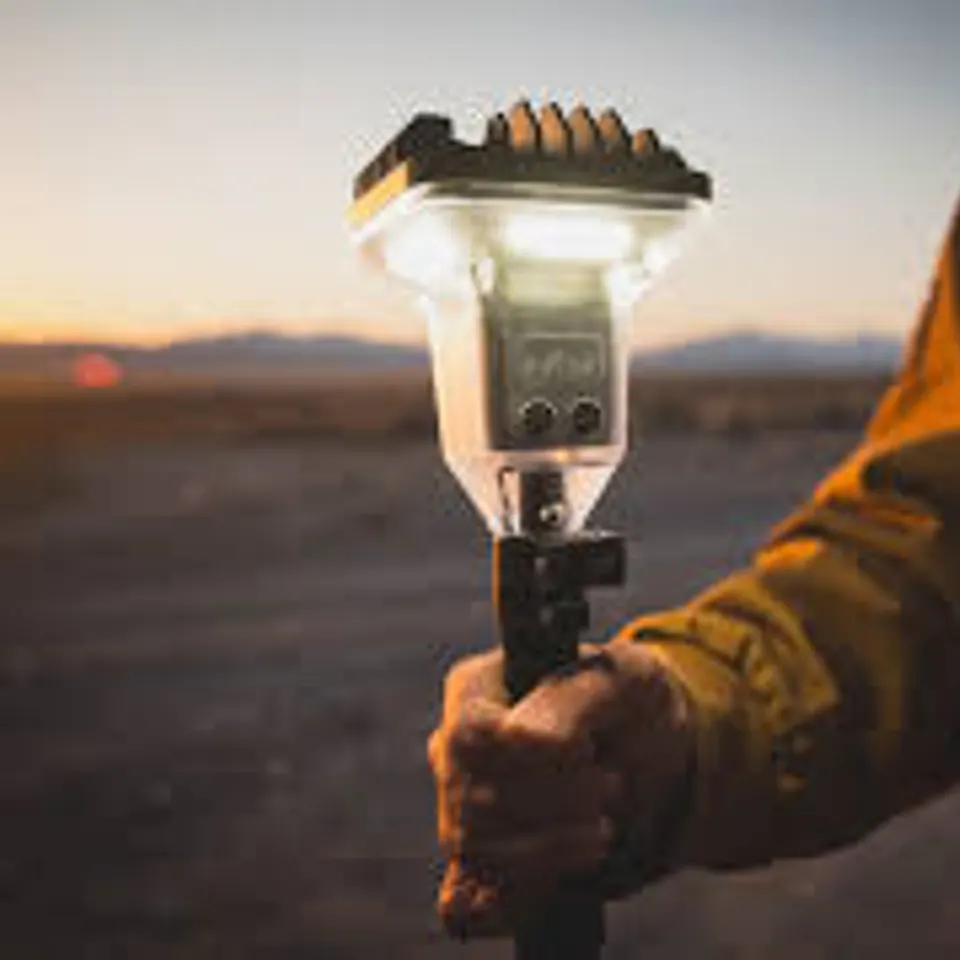 Portable camp lantern held outdoors
