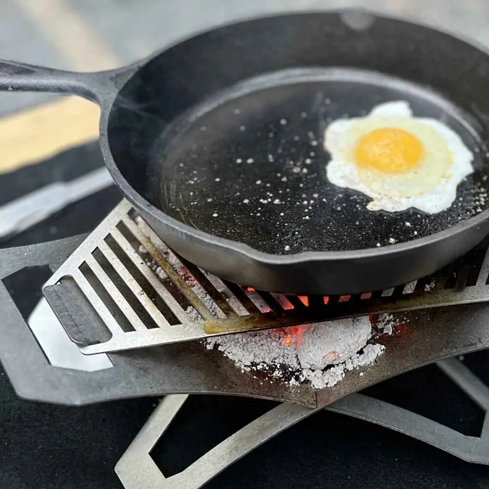 Cast iron skillet cooking an egg on camp kitchen gear