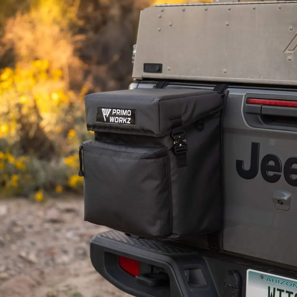 Soft storage bag mounted on the rear of an off-road vehicle
