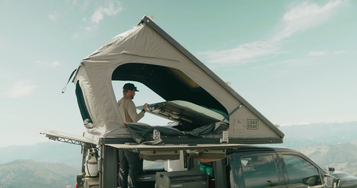 Truck camper interior bed platform lifted for storage access