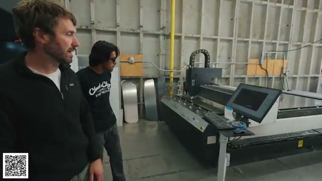 Thomas and a laser operator beside the fiber-laser control station