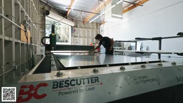 A sheet of aluminum positioned on the fiber-laser cutting table