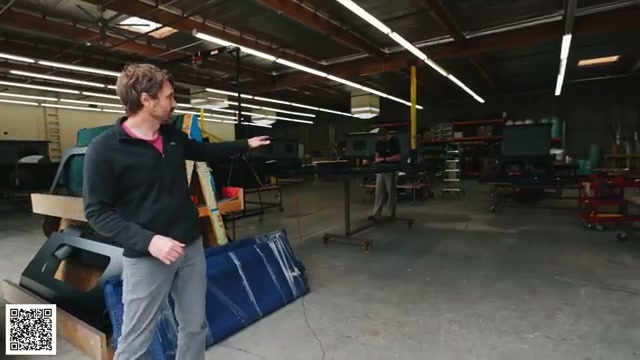 Thomas showing a roof component during camper assembly