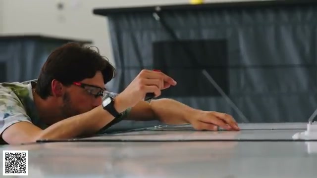 A worker checking a completed camper during the final stage